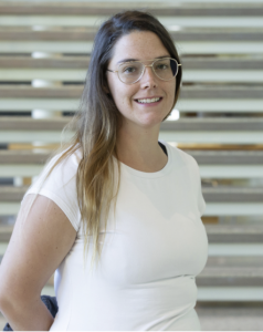 A woman in a white shirt, smiling. 